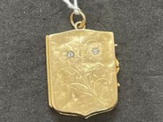 Jewellery: Yellow metal rectangular shaped hinged locket set with two diamonds, tests as 18ct gold.