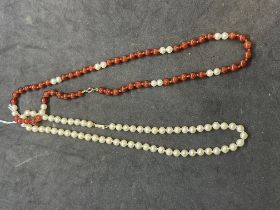 Jewellery: Pair of necklets one of 5.5mm cultured pearls with 9ct snap, 16ins, the other 6mm agate