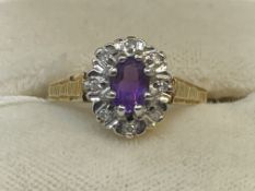 Jewellery: 9ct gold cluster set with an oval amethyst, estimated weight 0.60ct,