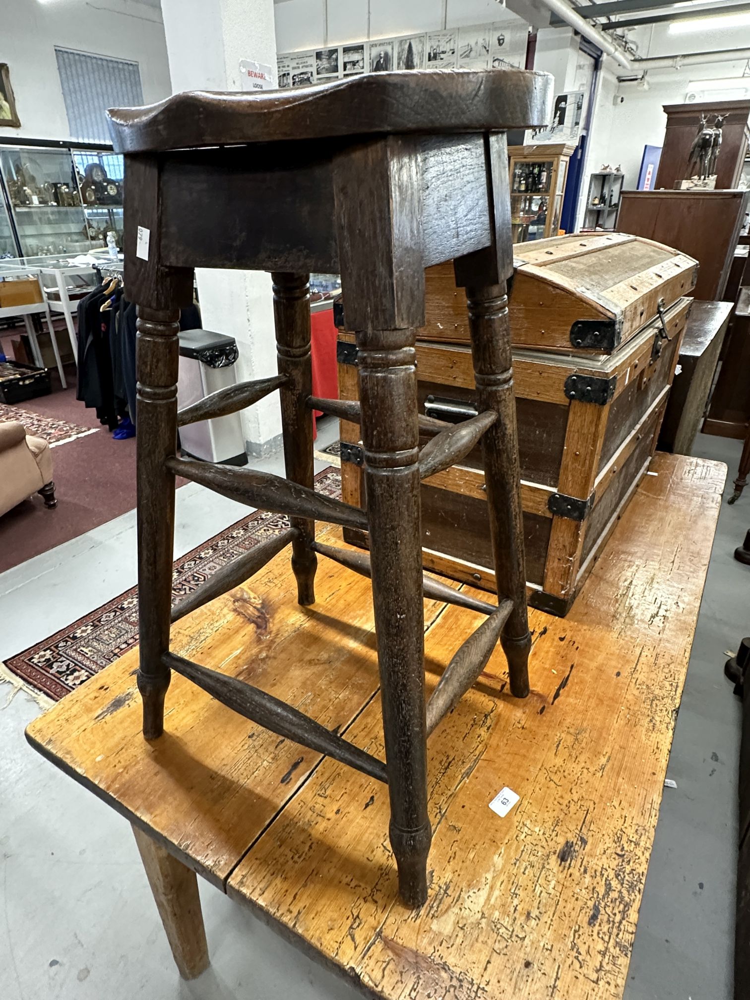 19th cent. G.W.R. Oak high stool, turned supports united by stretcher and stamped G.W.R under seat.