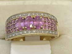 Jewellery: 18ct gold half hoop ring set with three oval pink sapphires, estimated weight of (3)