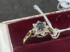 Jewellery: 9ct gold cluster set with an oval cut sapphire, estimated weight 0.40ct