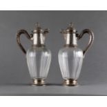 A PAIR OF FRENCH SILVER GILT AND CARVED GLASS DECANTERS ADORNED LIDS WITH PINECONE FINIAL