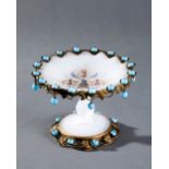 EUROPEAN OPAQUE GLASS VASE ON A STAND WITH DECORATION OF METALLIC GARLANDS OF LEAVES AND BLUE STONES