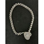 An 18 Carat White Gold Diamond Set Tennis Bracelet With Diamond Set Heart Clasp L65cm
