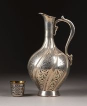 A SILVER AND NIELLO DECANTER AND A BEAKER