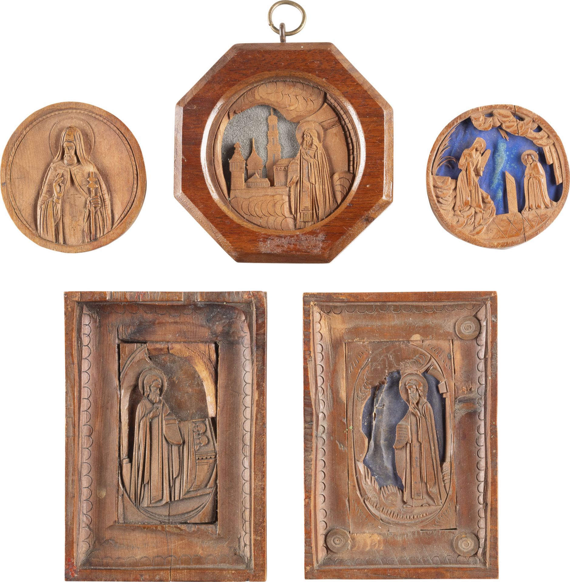 A COLLECTION OF FIVE CARVED WOODEN ICONS SHOWING THE ANNUNCIATION AND SELECTED SAINTS