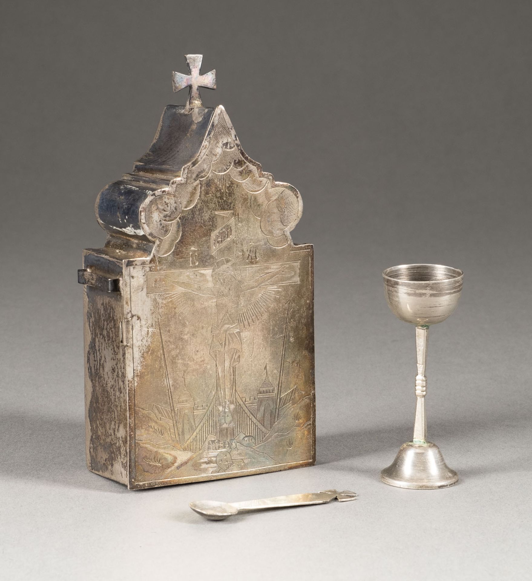 A SILVER TRAVELLING COMMUNION SET SHOWING THE CRUCIFIXION