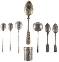 A COLLECTION OF A SILVER AND NIELLO BEAKER AND SEVEN SPOONS