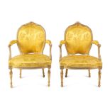 A Matched Pair of George III White-Painted and Parcel-Gilt Armchairs