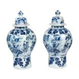 A Pair of Delftware Vases and Covers