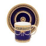 A Sevres Partially Beau Bleu Jewelled Porcelain Coffee Can and Saucer (Gobelet 'Litron' et sa Soucou