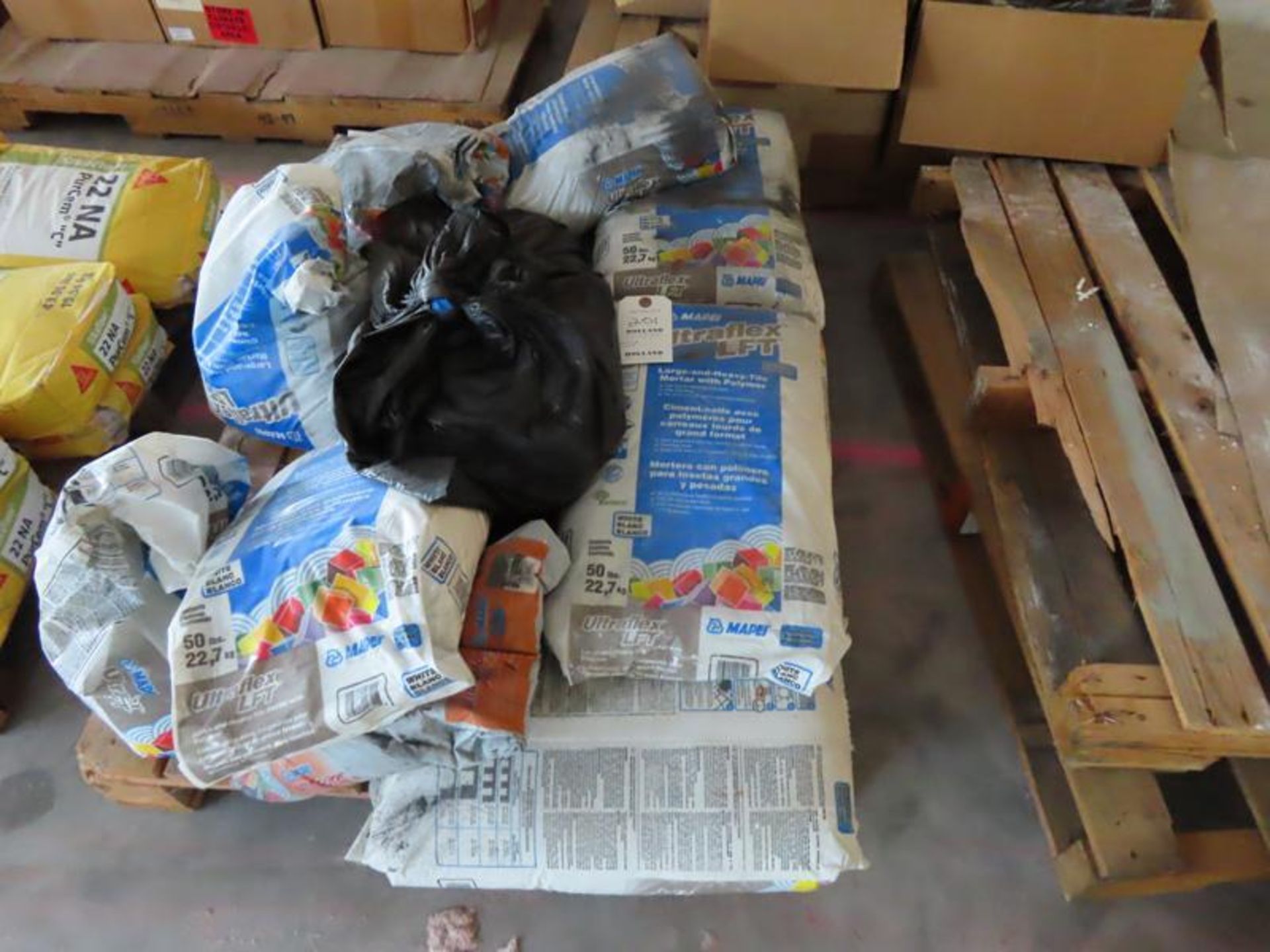 PALLET WITH 8 FULL BAGS AND A COUPLE OF PARTIAL BAGS OF ULTRAFLEX LFT HEAVY TILE MORTAR WITH POLYMER