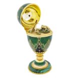 Asprey, 18K gold enamelled egg on a malachite base, opening up to reveal a swamp with lilypads and a