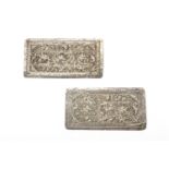 A PAIR OF REPOUSSE SILVER PILLOW ENDS