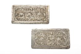 A PAIR OF REPOUSSE SILVER PILLOW ENDS