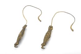 A PAIR OF REPOUSSE SILVER GILT CURTAIN HOOKS