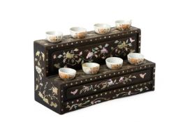 A MOTHER OF PEARL INLAID STAND WITH EIGHT SMALL TEA BOWLS