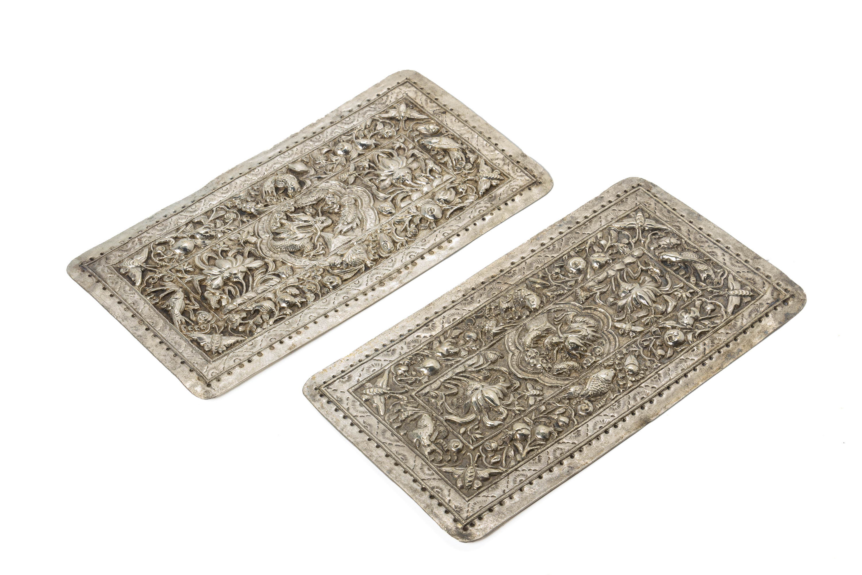 A PAIR OF REPOUSSE SILVER PILLOW ENDS - Image 2 of 3