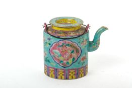 A TURQUOISE BLUE GROUND FAMILLE ROSE CYLINDRICAL TEAPOT