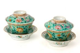 A PAIR OF TURQUOISE GROUND TEA BOWLS, STANDS AND COVERS