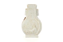 A SMALL WHITE RELIEF DECORATED BALUSTER VASE