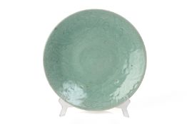 A LARGE CARVED CELADON CHARGER