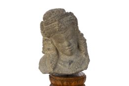 A JAVANESE CARVED VOLCANIC STONE HEAD OF A FEMALE GODDESS