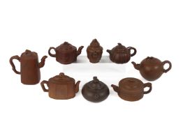 A GROUP OF EIGHT SMALL YIXING POTTERY TEAPOTS