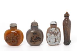 A GROUP OF FOUR CARVED AGATE AND HARDSTONE SNUFF BOTTLES