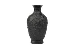 A RELIEF MOULDED BLACK GLAZED DRAGON VASE