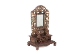 A CARVED, GILT AND RED LACQUER DRESSING TABLE MIRROR