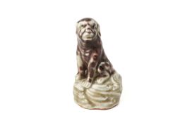 A SMALL GLAZED MODEL OF A DOG