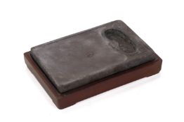 A RECTANGULAR CARVED INKSTONE WITH BOX