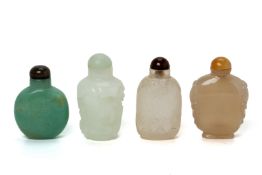 A GROUP OF FOUR JADE AND HARDSTONE SNUFF BOTTLES