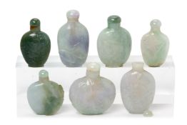 A GROUP OF SEVEN CARVED JADE SNUFF BOTTLES