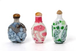 A GROUP OF THREE OVERLAID GLASS SNUFF BOTTLES
