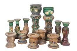 A LARGE GROUP OF GREEN AND BROWN GLAZED POTS AND STANDS