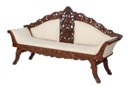 A CREAM UPHOLSTERED AND CARVED SETTEE