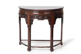 A CARVED HARDWOOD DEMI LUNE SIDE TABLE