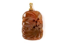 A CARVED JADEITE PENDANT