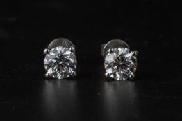 A PAIR OF DIAMOND STUD EARRINGS