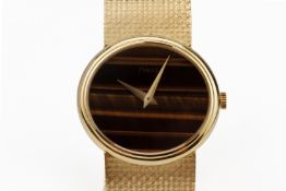 A PIAGET GOLD DRESS WATCH WITH TIGER'S EYE DIAL