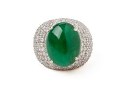 A LARGE EMERALD CABOCHON AND DIAMOND RING