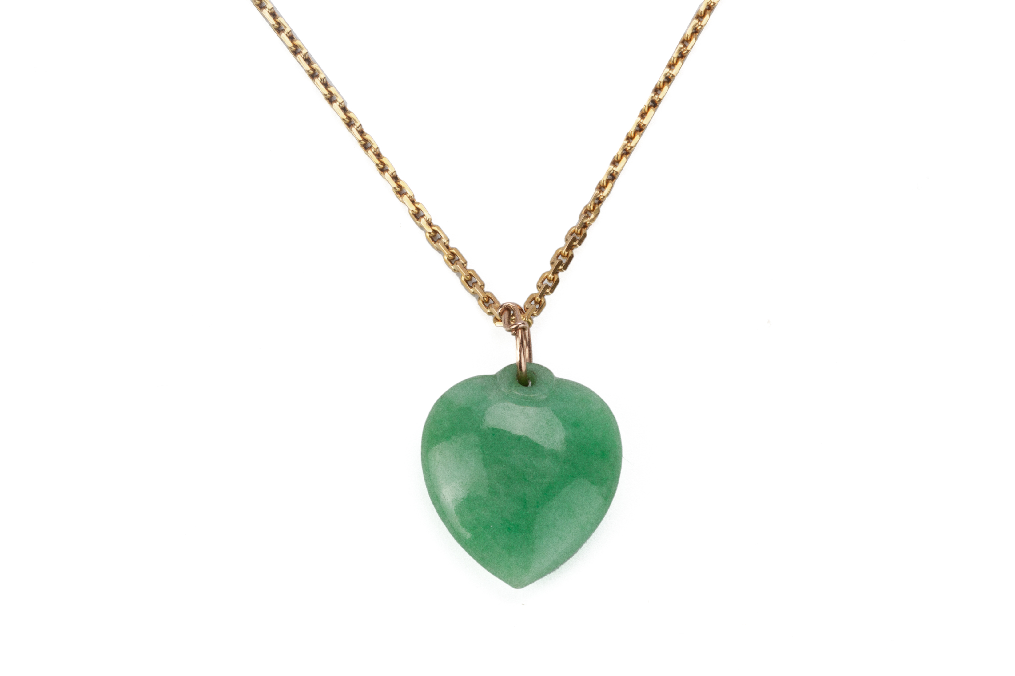 A HEART-SHAPED JADE PENDANT ON CHAIN