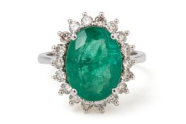 AN EMERALD AND DIAMOND CLUSTER RING