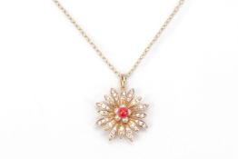 A PINK DIAMOND, CORAL AND SEED PEARL FLOWER PENDANT ON CHAIN