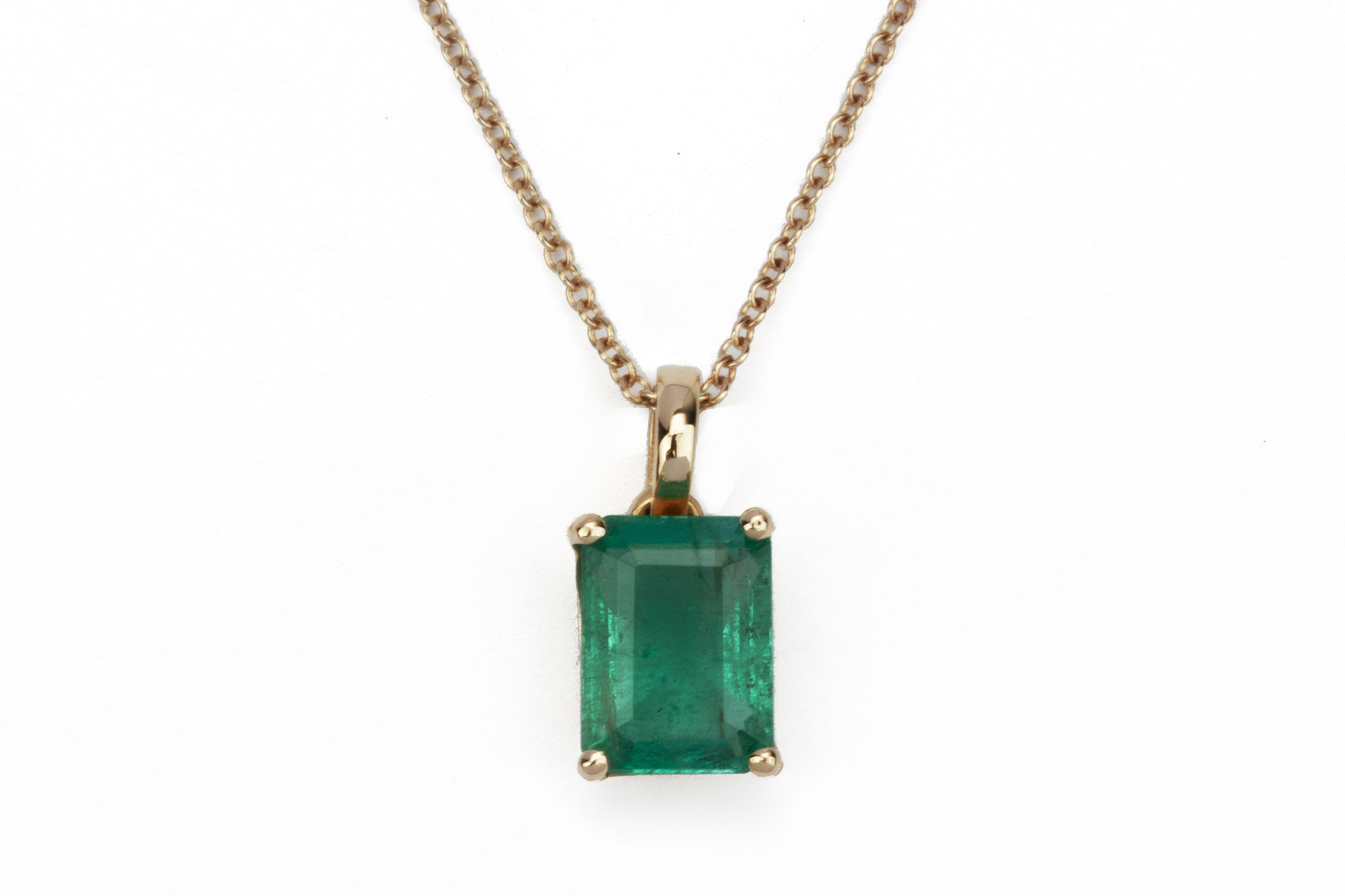 AN EMERALD PENDANT ON CHAIN