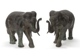 A PAIR OF CAST METAL MODELS OF ELEPHANTS