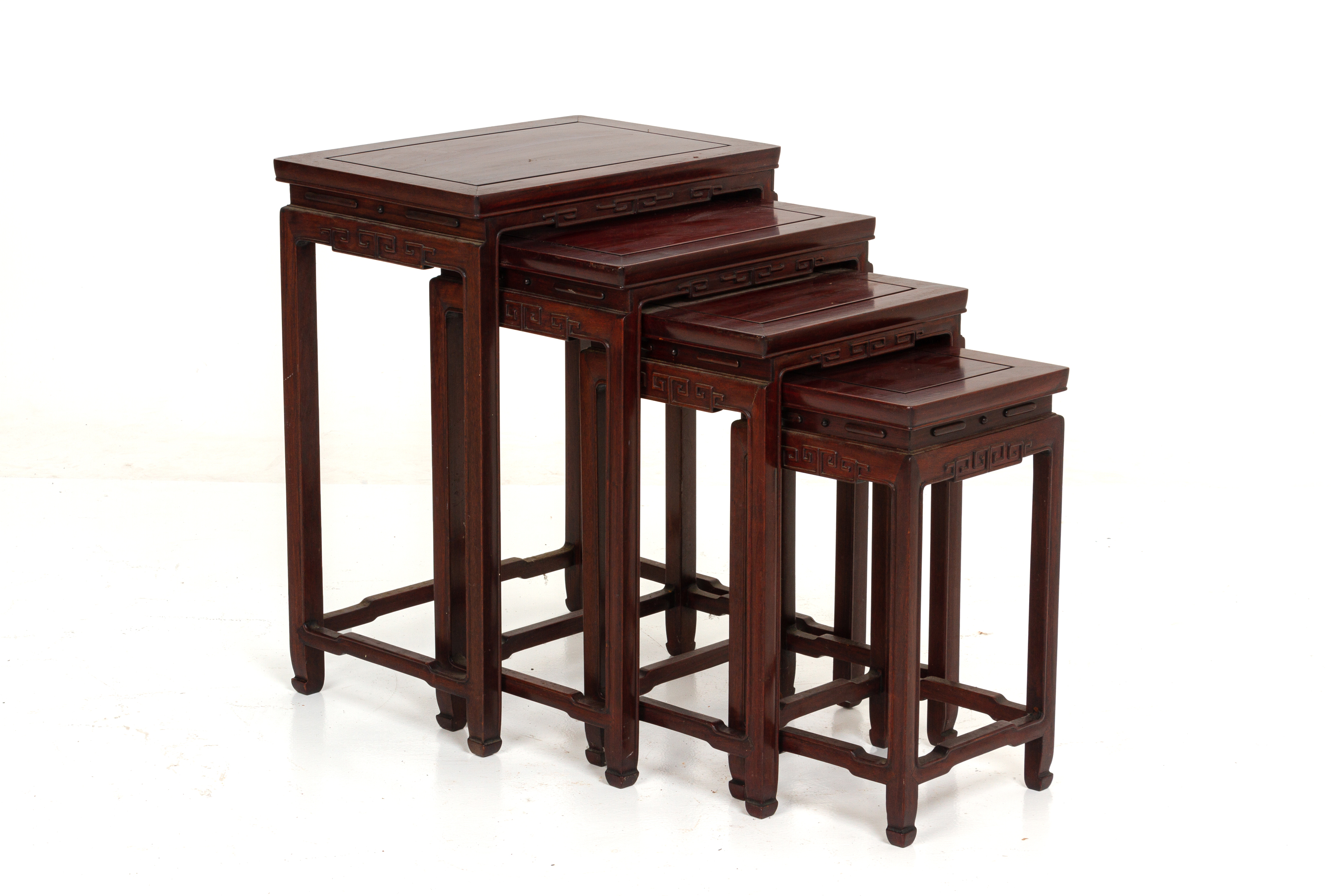 A SET OF FOUR HARDWOOD NESTING TABLES